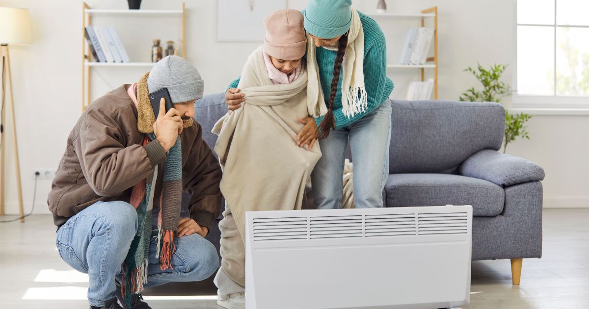 family standing around space heater