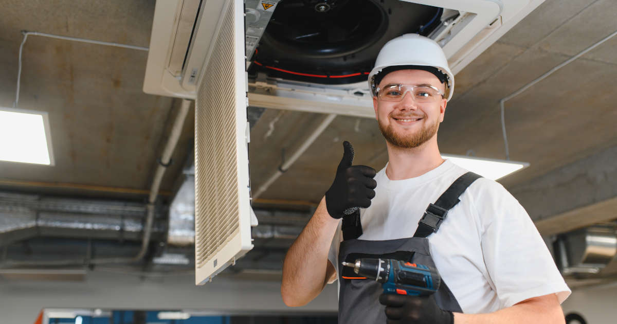 smiling HVAC technician making thumbs up