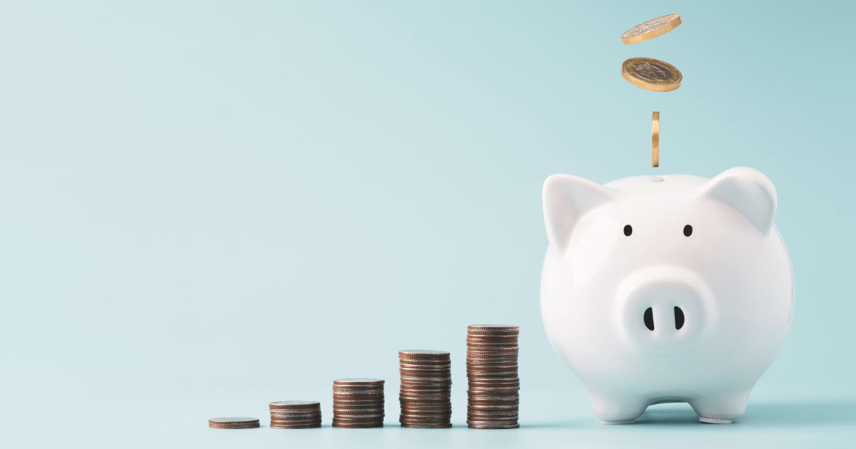 coins dropping into piggy bank